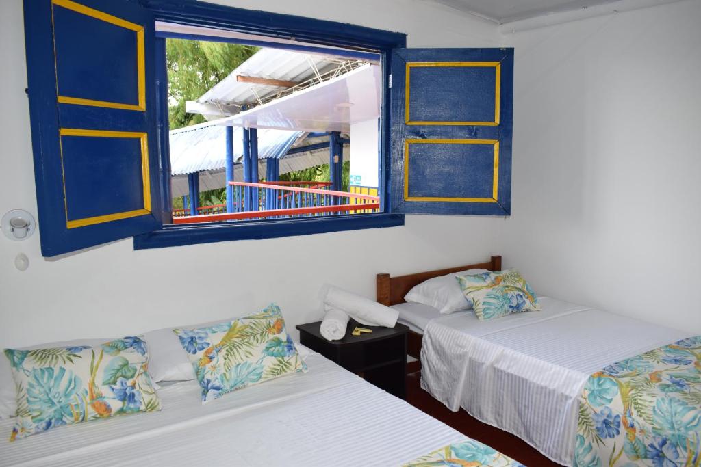 Postel nebo postele na pokoji v ubytování Finca Hotel el Edén del Quindío