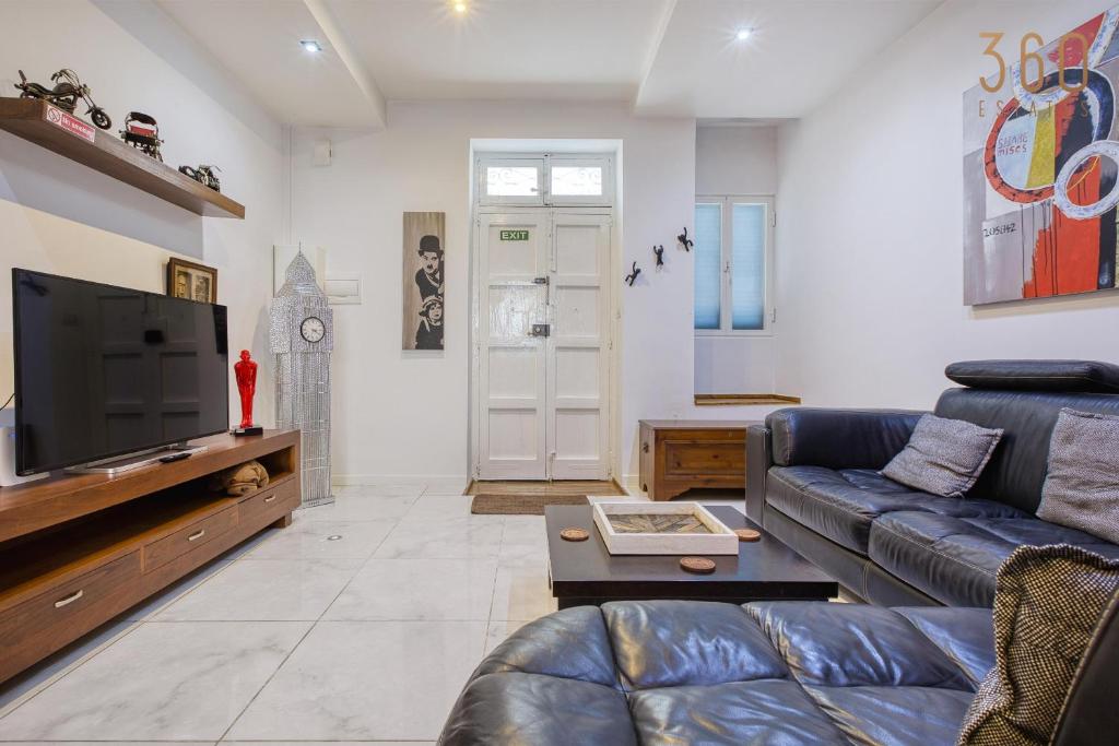 Μια τηλεόραση ή/και κέντρο ψυχαγωγίας στο Sunlit Rabat Maisonette with Private Terrace & BBQ by 360 Estates