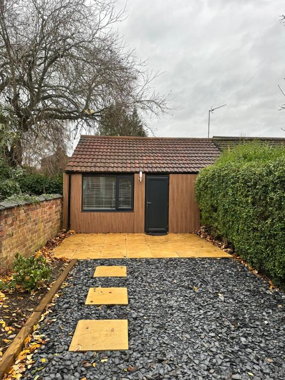 a house with a door and a building at Kettering Railway Lodge in Northamtonshire