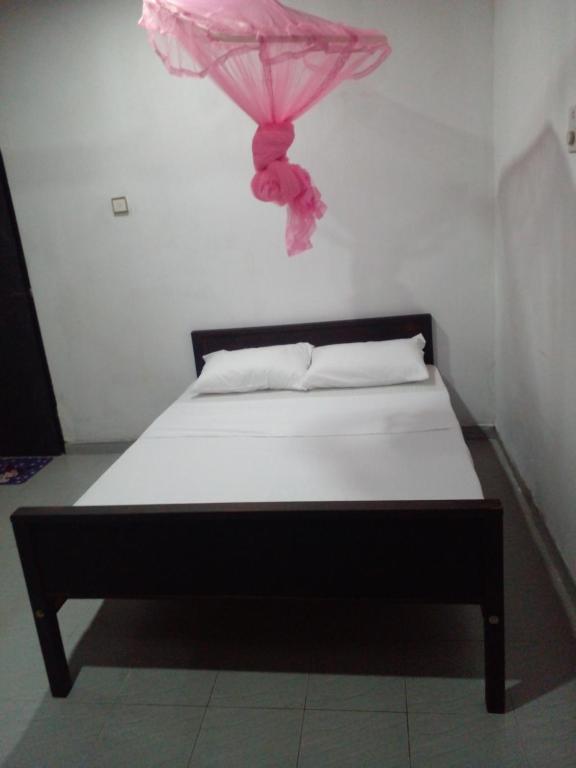 Ένα ή περισσότερα κρεβάτια σε δωμάτιο στο chula,s Home Stay