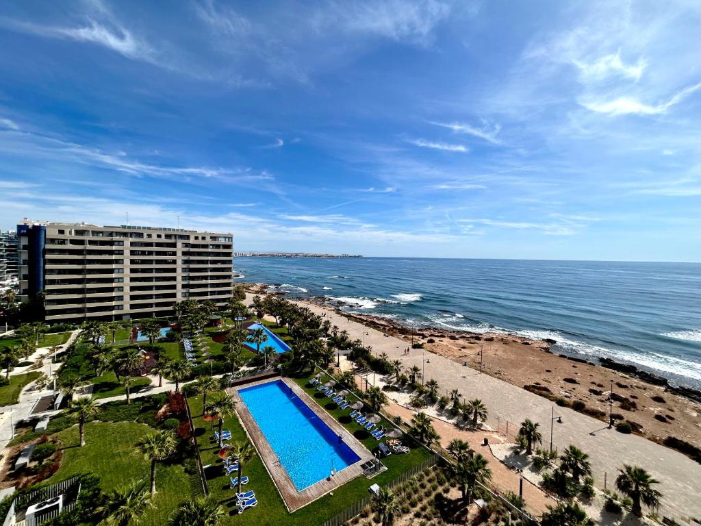 an aerial view of the beach and the ocean at Luxury Sea View - PANORAMA MAR- PUNTA PRIMA by GrupoQuattro in Punta Prima