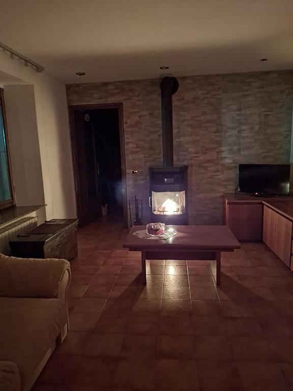a living room with a wood stove in a room at Il Borgo By Phoenix in Olmo al Brembo