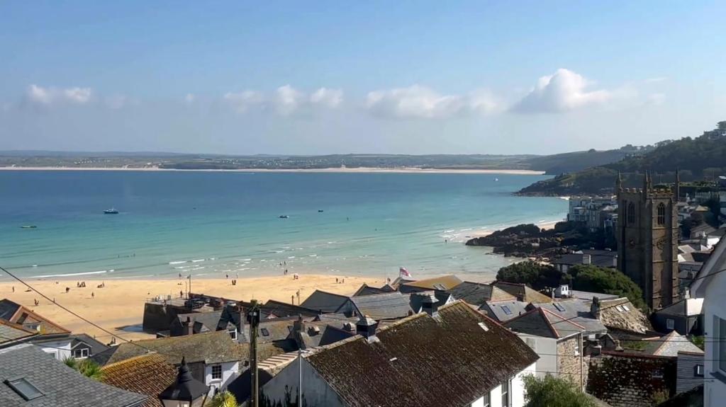 uitzicht op een strand met gebouwen en huizen bij Victoria Residences in St Ives