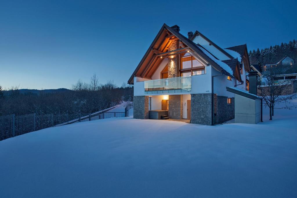 a house in the snow in the winter at Komforna planinska kuća za odmor in Mrkopalj