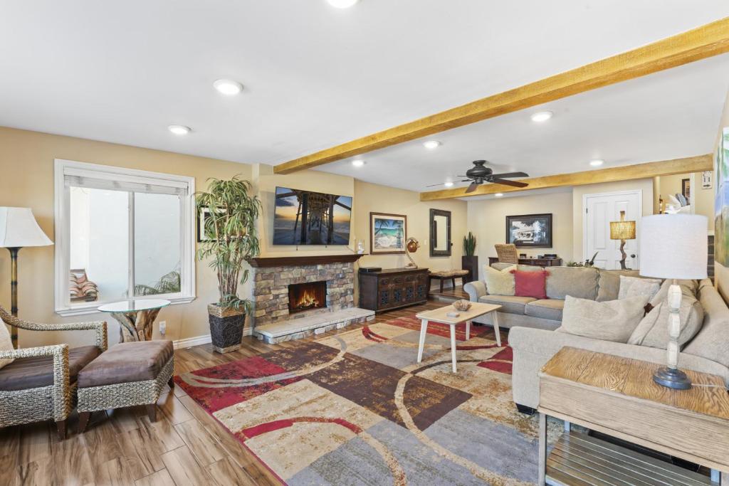 a living room filled with furniture and a fireplace at Bright 3BR Beach Condo Near Casino and Ole Hanson in San Clemente