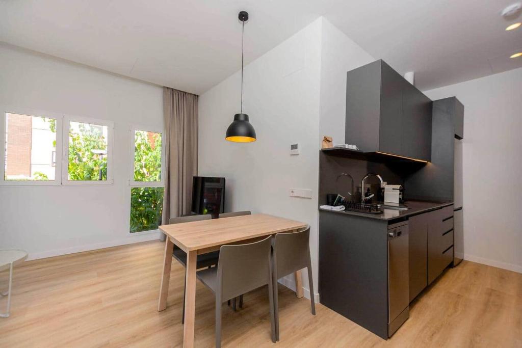 a kitchen with a wooden table and a dining room at Stancia Benimaclet - Studio 7 in Valencia