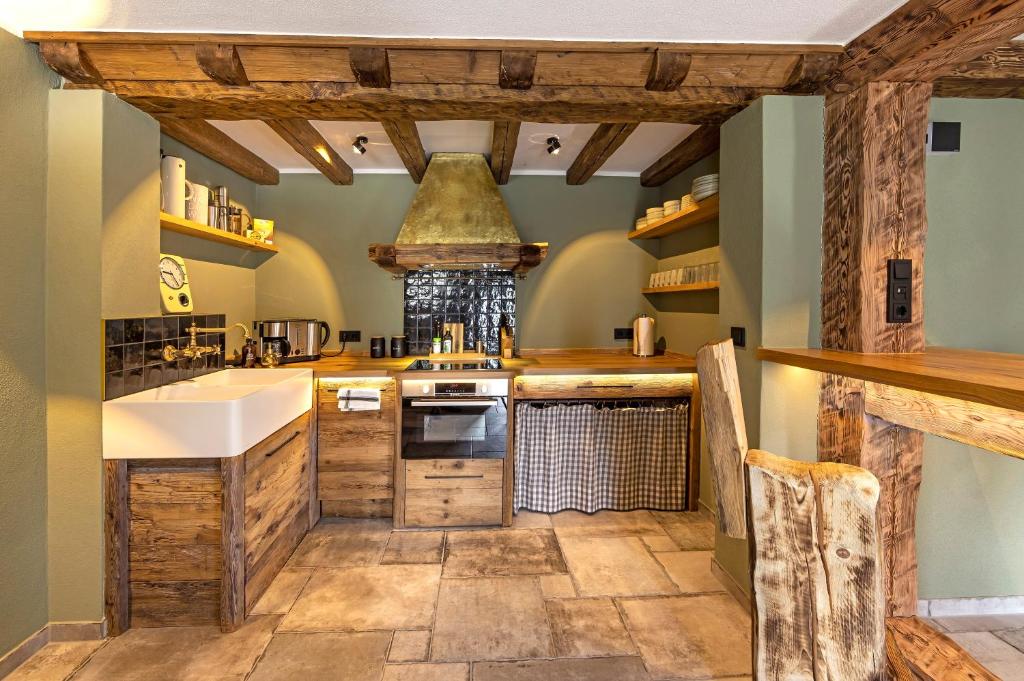 a large kitchen with wooden counters and a sink at Eden Escapes in Olsberg