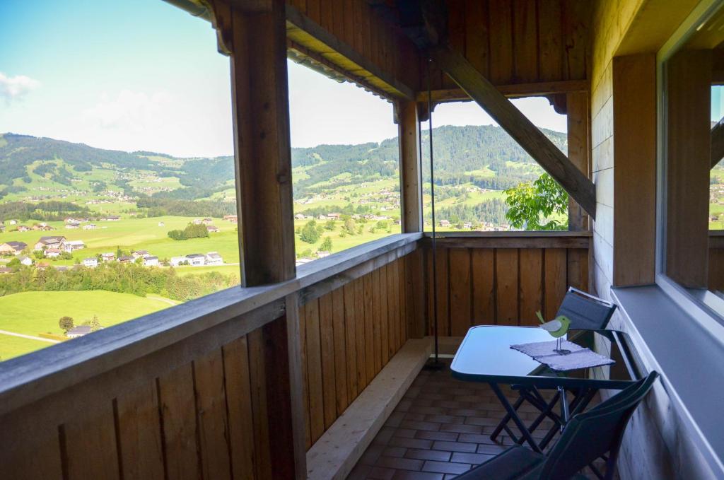 a room with a table and chairs on a balcony at Ferienwohnung Kaspar Natter in Egg