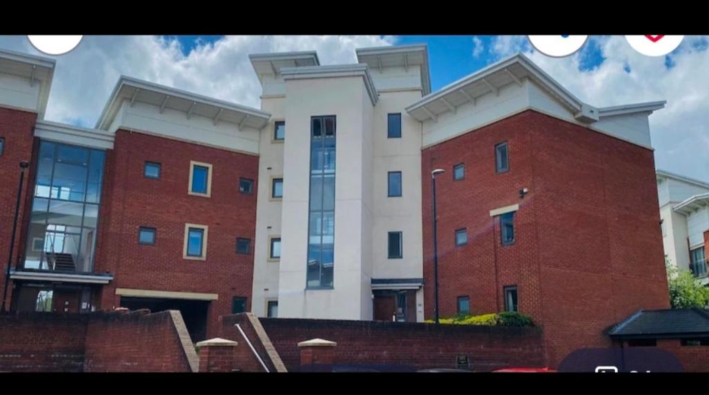 a large red and white building in front at Olive Den in Wolverhampton