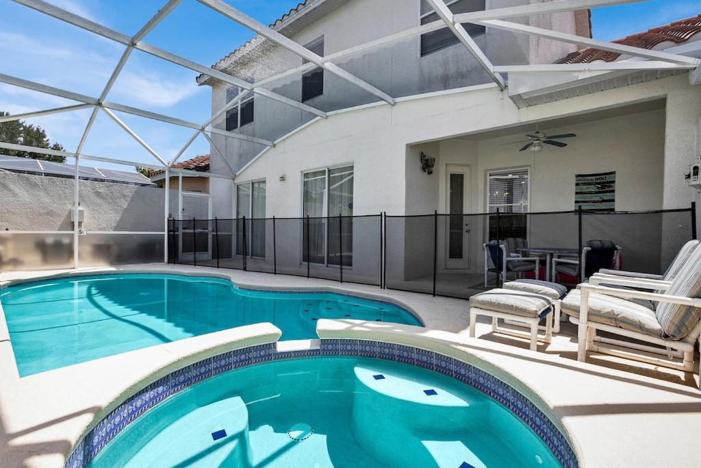 a swimming pool in the backyard of a house at Much Needed Private Relaxation Home in Davenport