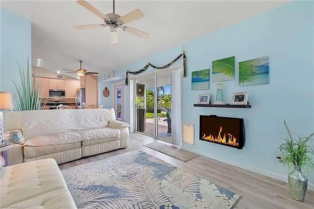 a living room with a couch and a fireplace at Summer Getaway (Gulf-access retreat) in Cape Coral
