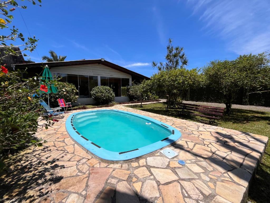 a swimming pool in front of a house at Pepa Kingdom in Matinhos