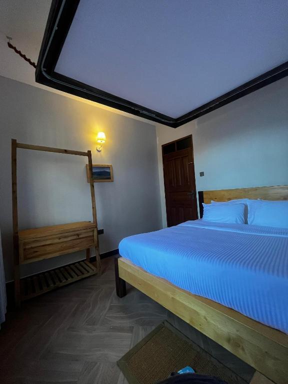 a bedroom with a large bed in a room at Cj VILLA in Karatu