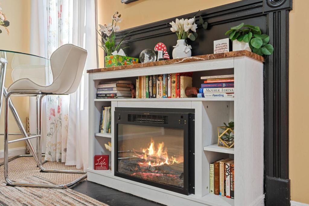 a fireplace in a living room with a fire in it at Fireplace • Grill • Gym‑Ready • Near Bull Run in Centreville