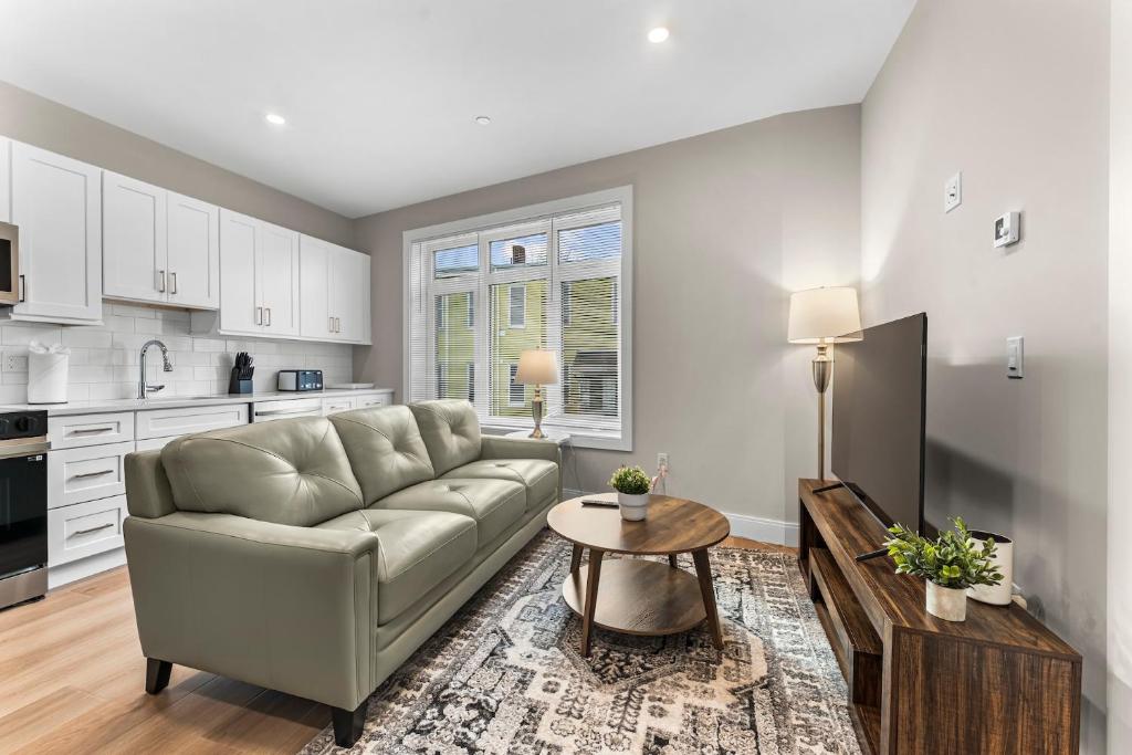 a living room with a couch and a table at Luxury 2BR near Cabmridge in Somerville