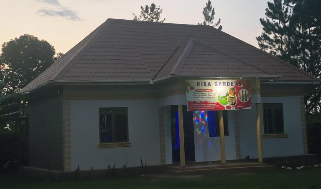 a small house with a sign in front of it at Risa Camping Site in Kiyunga