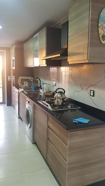 a kitchen with a sink and a washing machine at Apartment with piscine in Mansouria