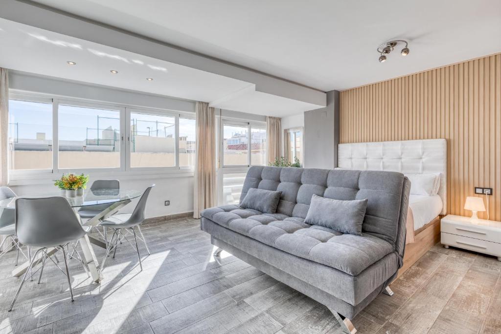 a living room with a couch and a table at Estepona Real Apartamentos in Estepona