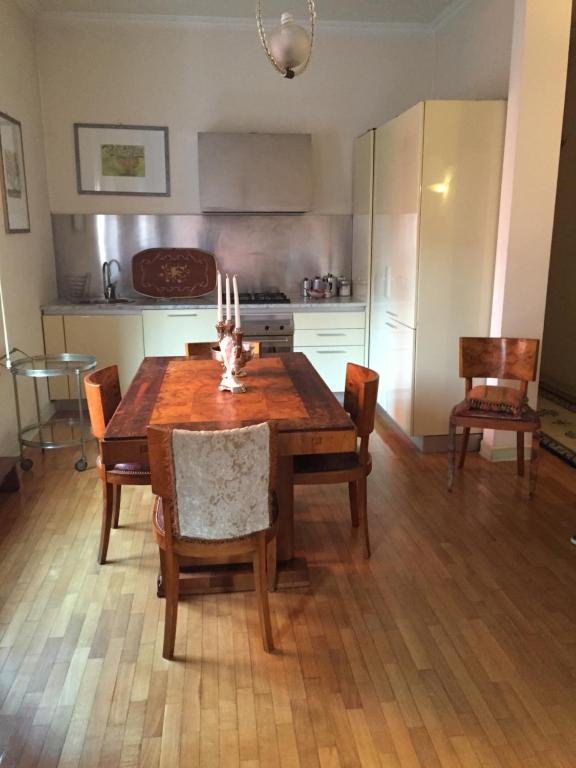 a kitchen with a wooden table with chairs and a stove at B&B san Biagio parma in Parma