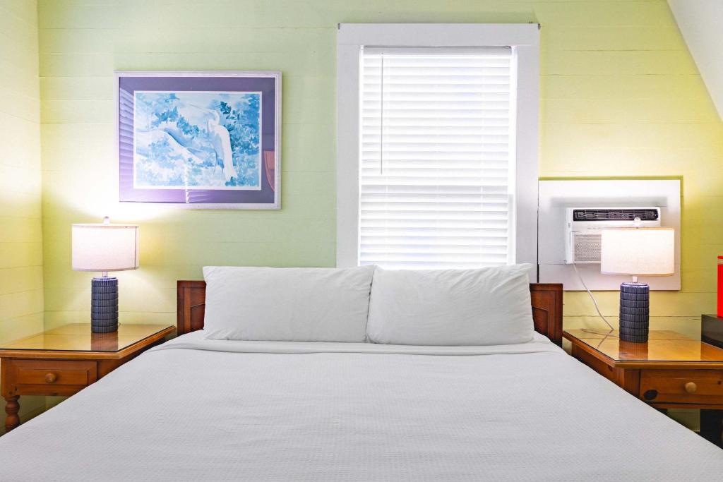 a bedroom with a white bed and two lamps at Curry House - Pool, King Bed & Balcony! Room 7 in Key West