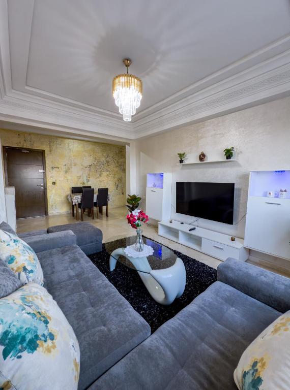 a living room with a couch and a tv at artisanat in Mohammedia