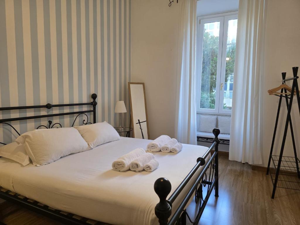 a bedroom with a bed with towels on it at MR House - by Be Your Home in Rome