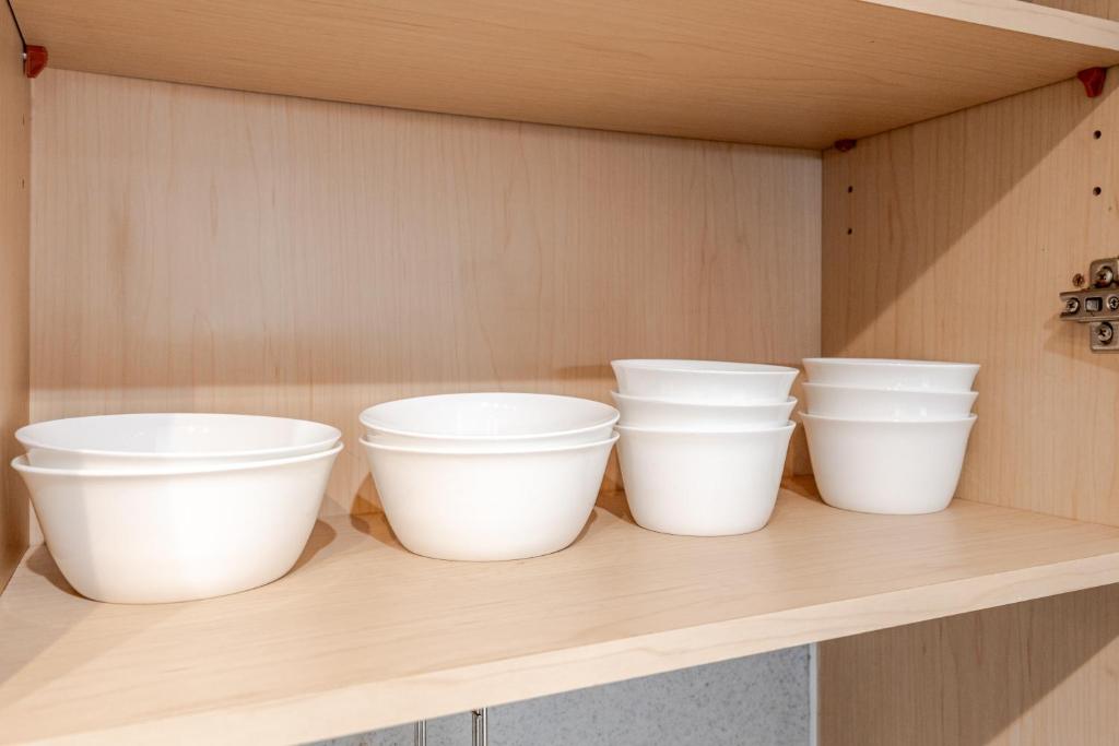 vier witte emmers die op een plank staan bij Hongdae BIG FAMILY Stay in Seoul