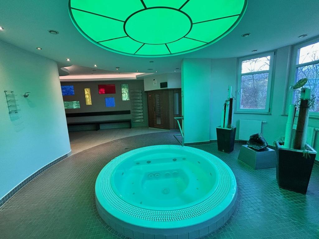 a large tub in the middle of a room at Hotel Phönix in Bad Füssing