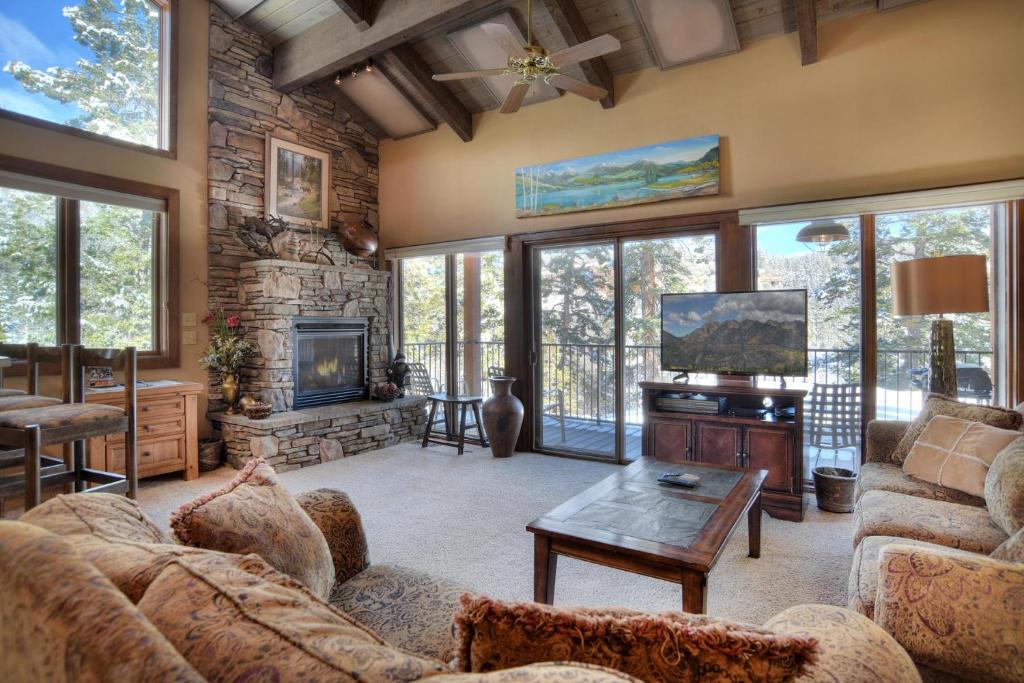 a living room with couches and a tv and a fireplace at Tamarron HighPoint - 599-600 in Durango
