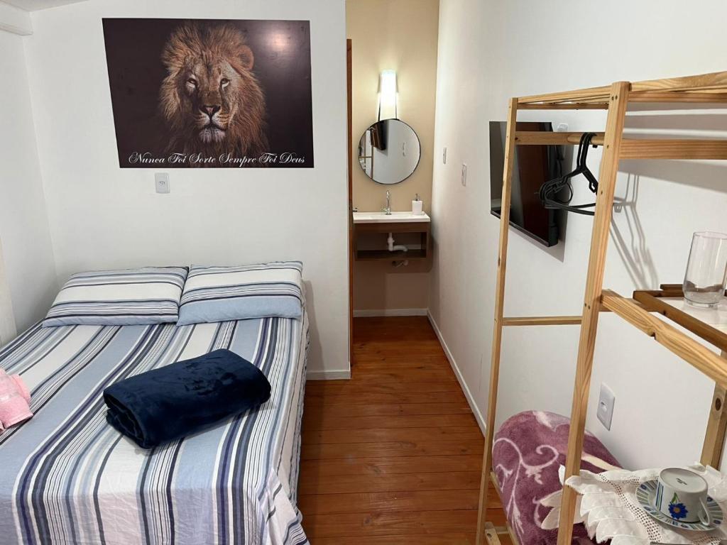 a bedroom with a bunk bed with a lion poster on the wall at Brisa da Ilha - Estúdios ao lado do aeroporto in Florianópolis