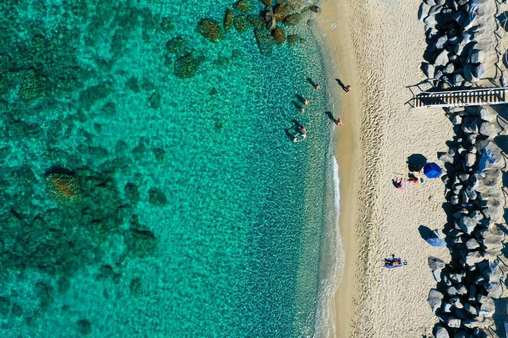 an overhead view of a beach with people and the ocean at Capo Vaticano Suites in Capo Vaticano