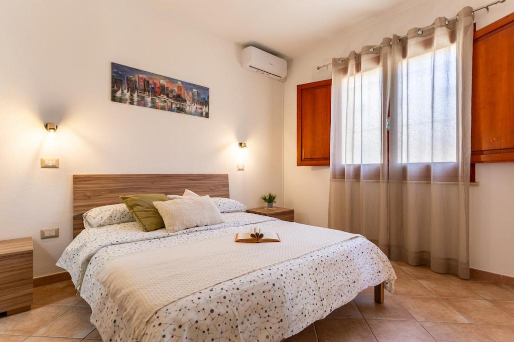 a bedroom with a large bed and a window at Casa Teo in Monastir