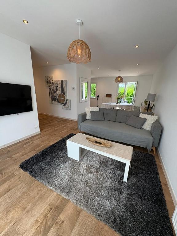 a living room with a couch and a coffee table at Ker'mima in Antoigné Châtellerault in Châtellerault