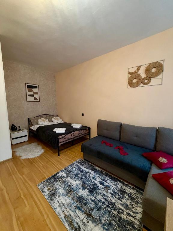 a living room with a couch and a bed at Rynek Ratusz in Wrocław