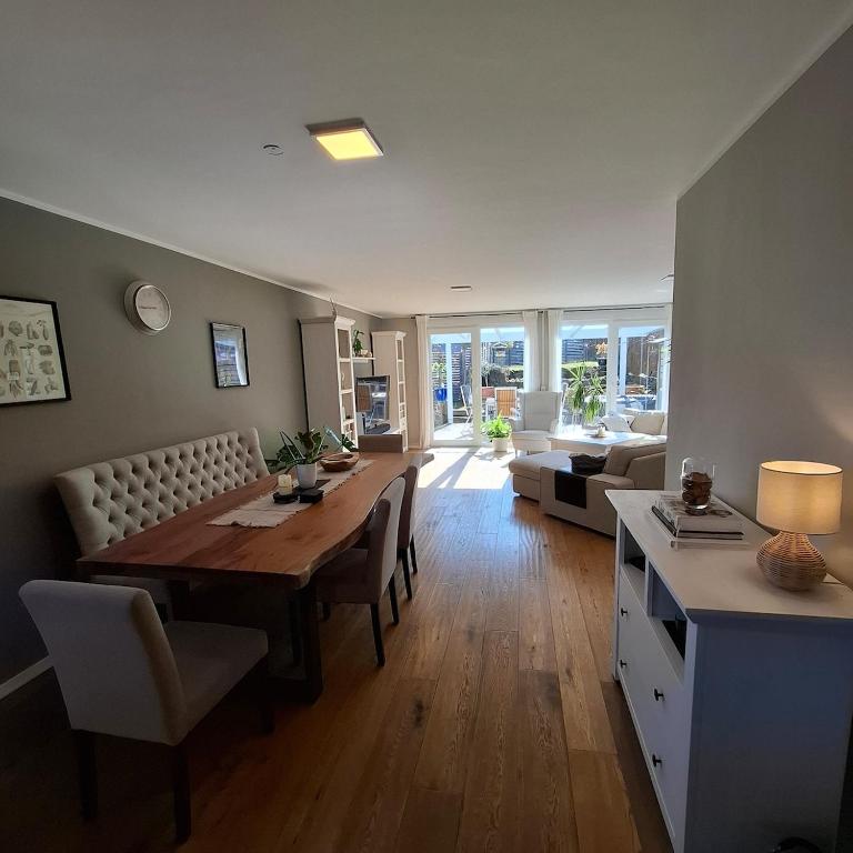a living room with a table and a couch at Haus am Tor zur Eifel in Mechernich