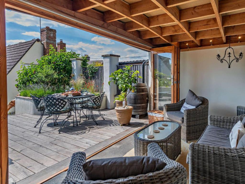 an outdoor patio with a table and chairs at 2 Bed in Winterborne Stickland 95140 in Winterborne Stickland