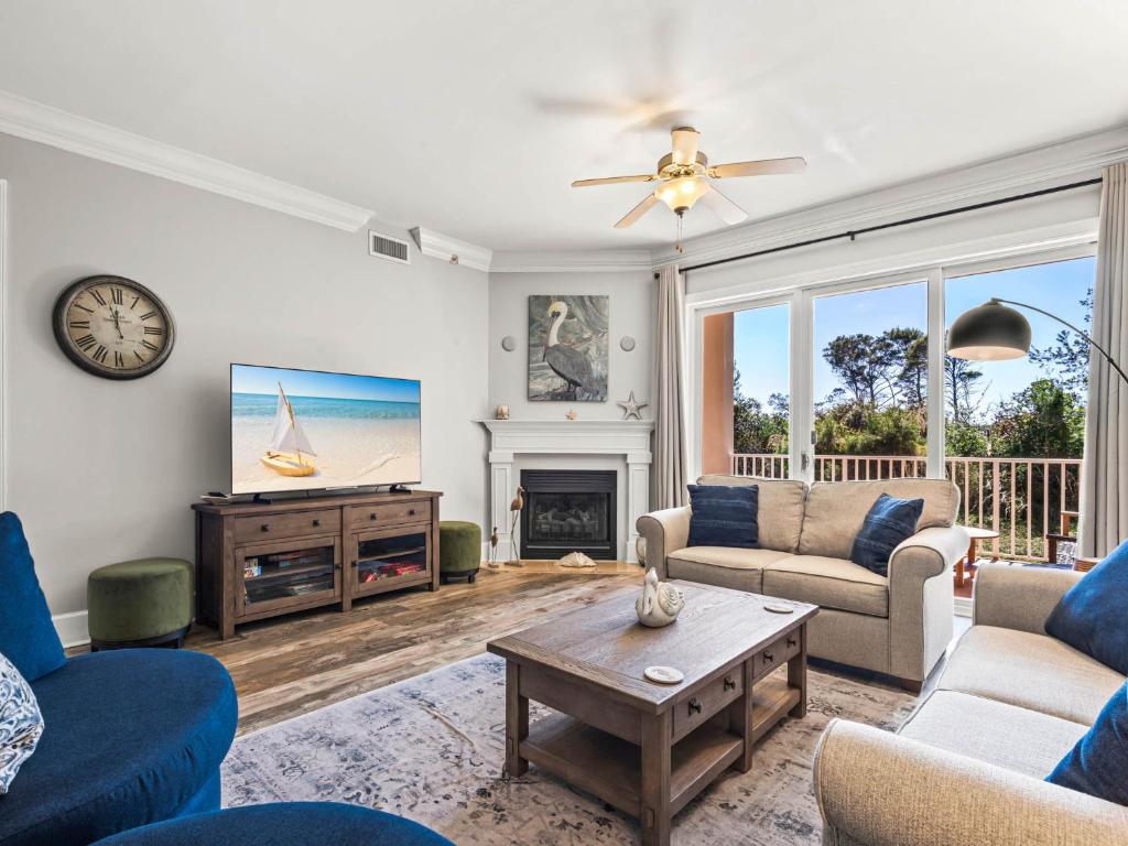 a living room with a couch and a table at Sanctuary at Redfish 1106 by Newman-Dailey in Blue Mountain Beach