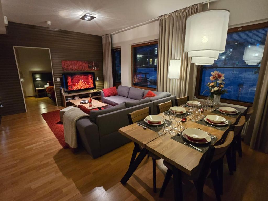 a living room with a couch and a table at Ylläs Chalet 9212 in Ylläsjärvi