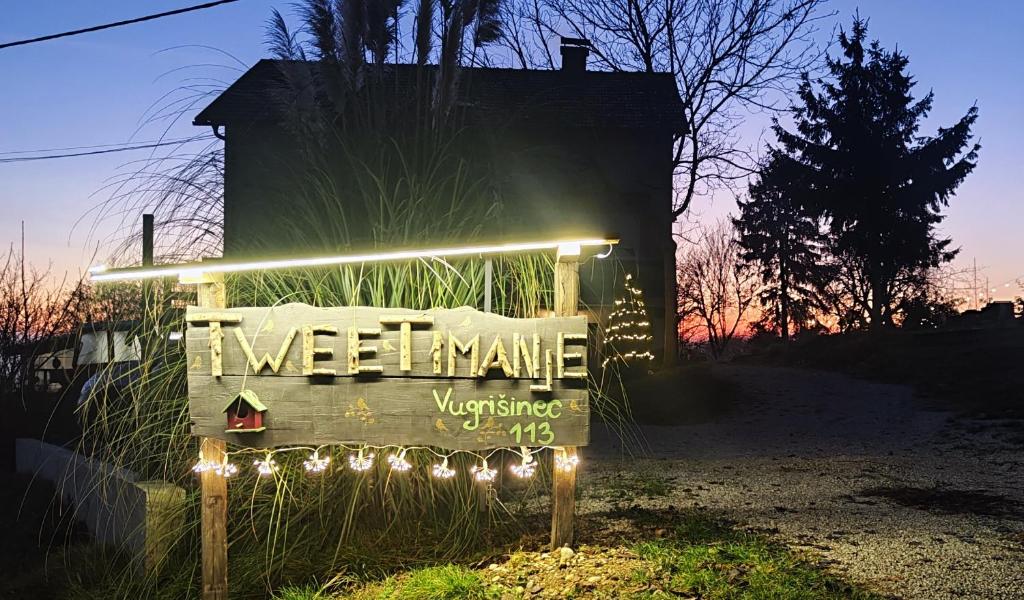 a welcome sign with lights on the side of a house at Tweet Apartments with Sauna and optional Breakfast Close To Terme Sveti Martin in Štrigova