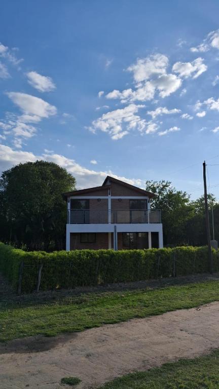 a house with a fence in front of it at Lo de Abu in Villa Las Rosas