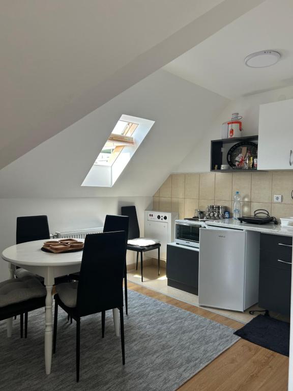 a kitchen with a table and chairs in a room at Apartman Ilić in Divčibare
