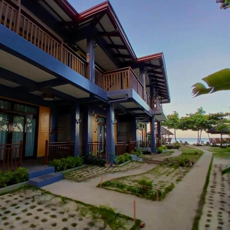 a building with a balcony with the ocean in the background at Takbo Beach Resort in General Luna