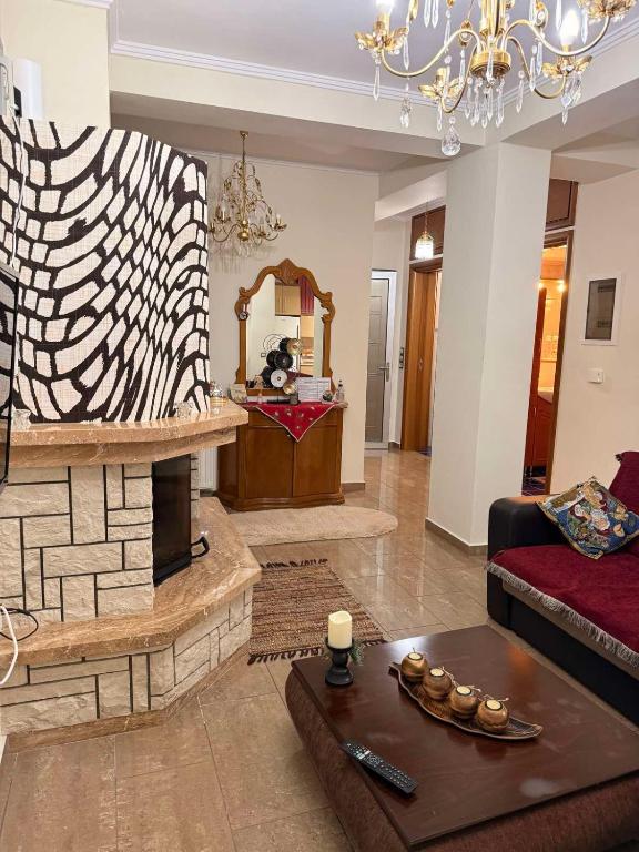 a living room with a couch and a fireplace at g.home in Tríkala