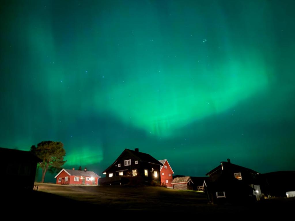 an image of the aurora in the sky over houses at Skåbu Camping in Skåbu