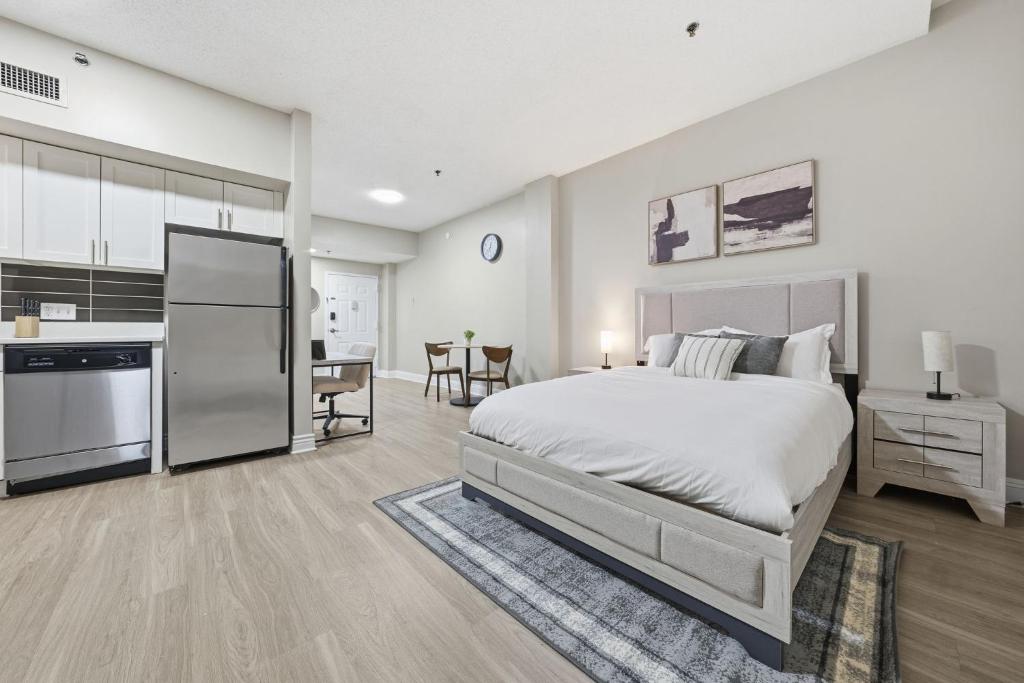 a bedroom with a large bed and a kitchen at Chic Studio Retreat in New Haven in New Haven