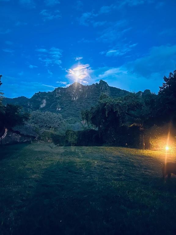 a view of a mountain with the sun shining on it at Bambu Villas Wellness Center in Amatlán