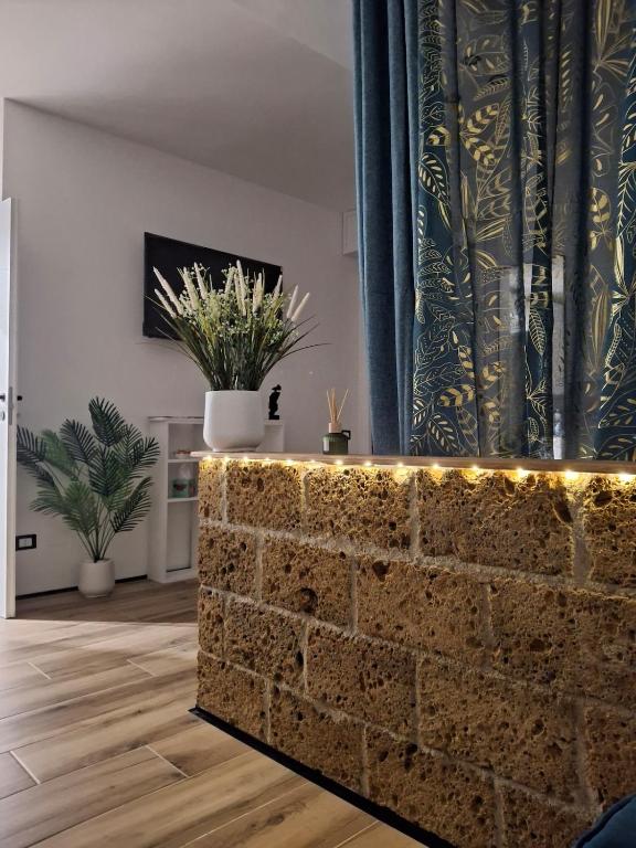 a brick wall with lights in a living room at RELAIS SUITE Modena Parc in Modena