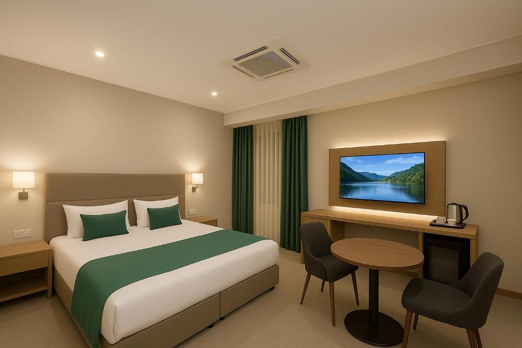 Ένα ή περισσότερα κρεβάτια σε δωμάτιο στο Khatai Aura Hotel