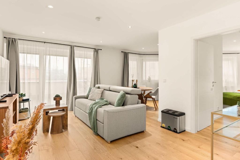 a living room with a couch and a table at Superior Apartment Dingolfing - Design & Komfort in Dingolfing