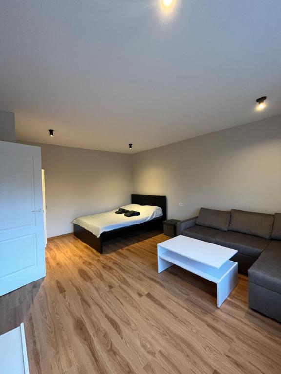 a living room with a couch and a bed at Cozy Stay Dubulti in Jūrmala